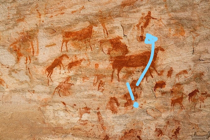 A cave painting depicting animals, humans, and Dennis B. Nighter in red, with a blue arrow and question mark pointing to Dennis.